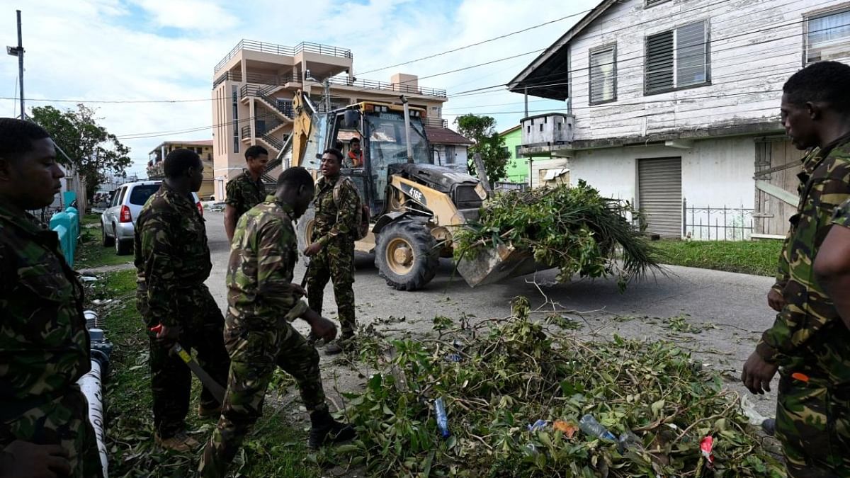 Soldiers remove fallen trees after the passage of Hurricane Lisa in Belize City. Credit: AFP Photo