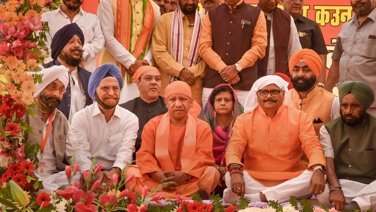 Uttar Pradesh Chief Minister Yogi Adityanath with Deputy Chief Minister Brajesh Pathak attends the birth anniversary celebrations of Guru Nanak Dev at DAV College in Lucknow. Credit: PTI Photo