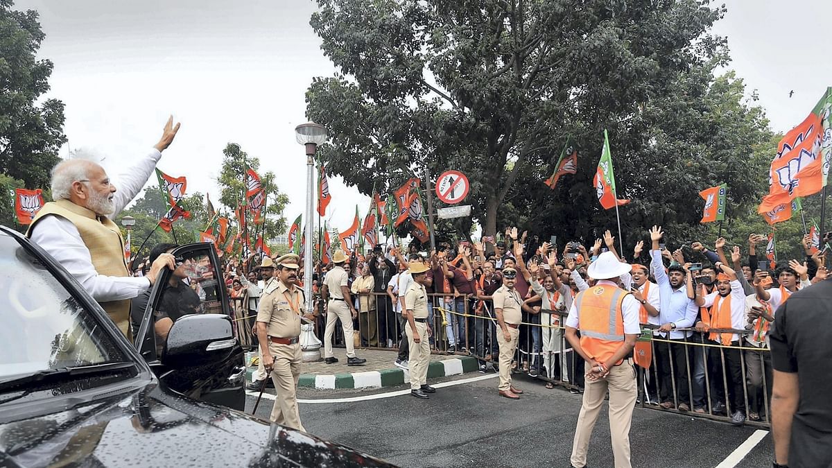 Standing on the 'running board' of his car, Modi greeted the crowd, many of whom were seen chanting 'Modi, Modi' slogans and holding BJP flags. Credit: Twitter/@narendramodi