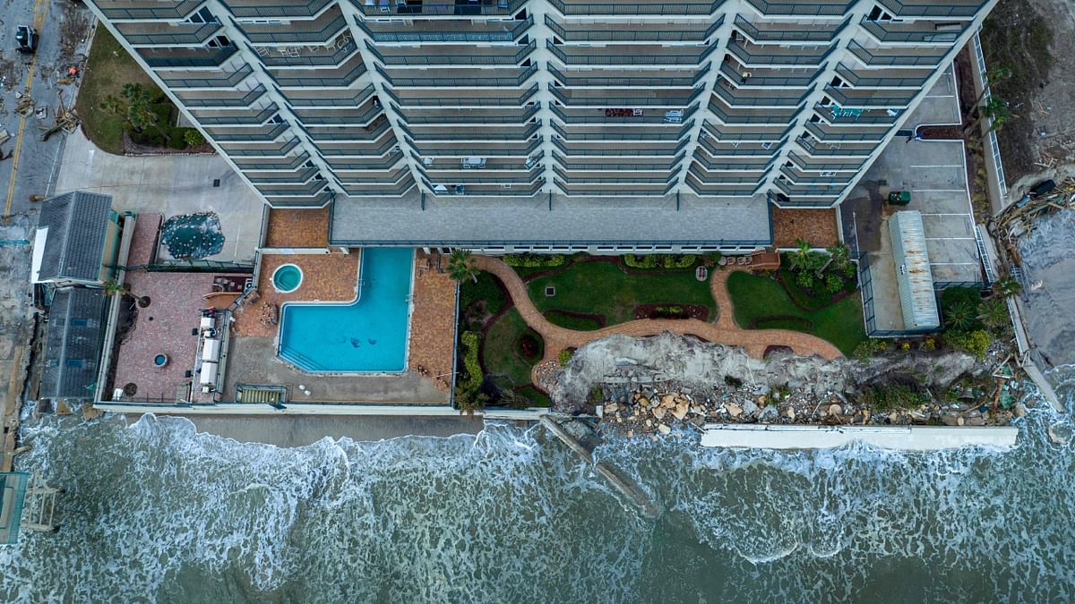 This aerial view shows the damaged backyard of a beachfront apartment building in the aftermath of Hurricane Nicole at Daytona Beach, Florida, on November 11, 2022. Credit: AFP Photo