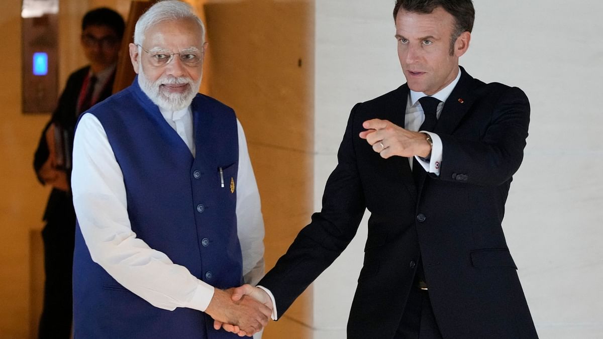 PM Narendra Modi and French President Emmanuel Macron meet before a working lunch on the sidelines of the G20 Summit in Nusa Dua, Bali. Credit: AFP Photo