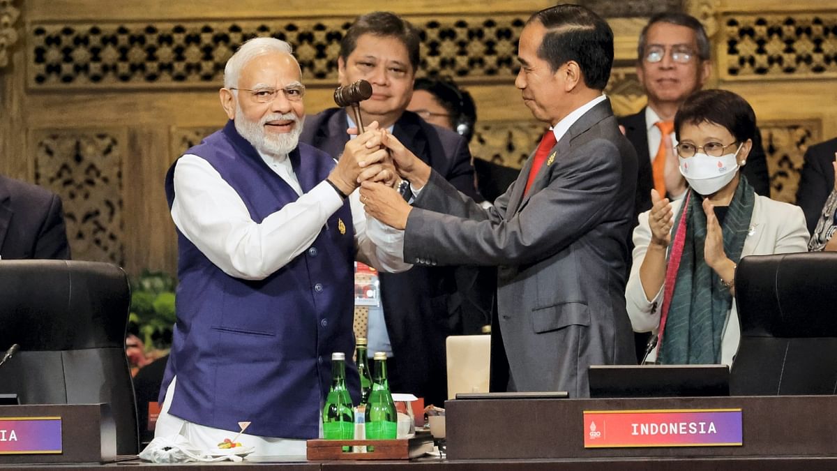 Prime Minister Narendra Modi with Indonesia's President Joko Widodo during the handover ceremony at the G20 Leaders' Summit, in Nusa Dua, Bali. Credit: AP Photo