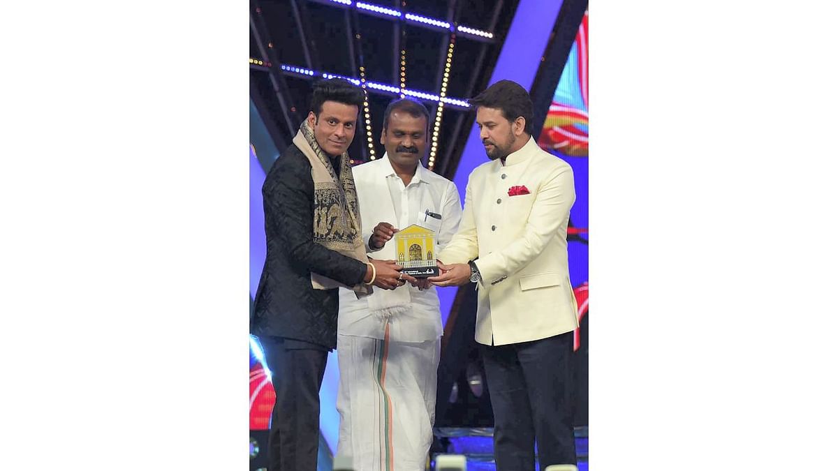 Anurag Thakur and Dr L Murugan felicitate Bollywood actor Manoj Bajpayee during the opening ceremony of the 53rd International Film Festival of India (IFFI), in Goa. Credit: Twitter/@IFFIGoa