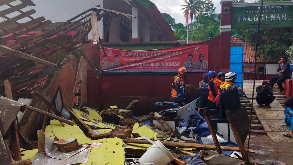 Rescuers arrive on spot to inspect the classroom that was destroyed by the earthquake. Credit: AP/PTI Photo