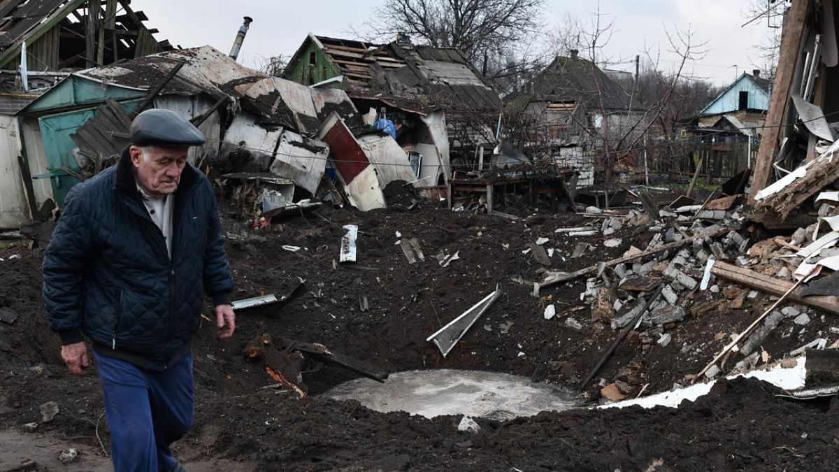 A man walks near a crater and his house that was damaged after Russian shelling in Kramatorsk, Ukraine. Credit: AP/PTI Photo