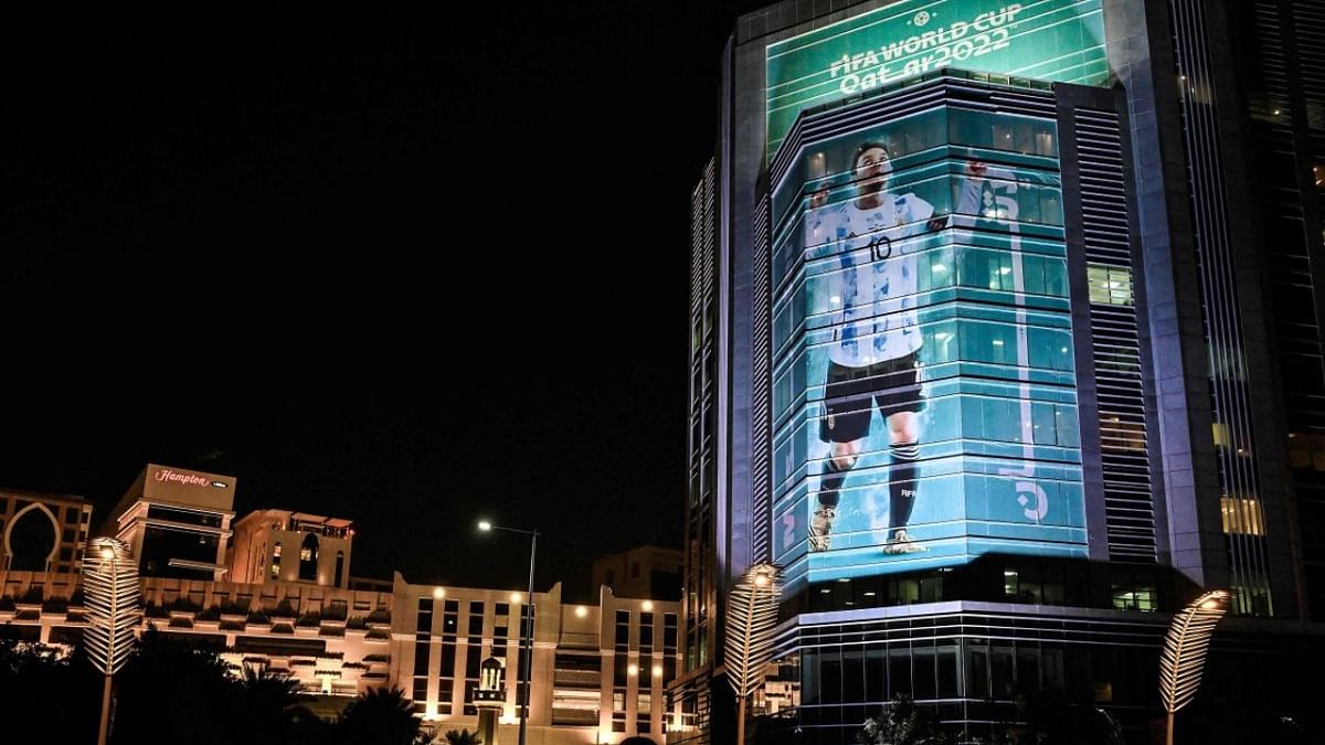 An image of Argentina's forward Lionel Messi decorates a building's facade in Doha on November 22, 2022, during of the Qatar 2022 World Cup football tournament. Credit: AFP Photo