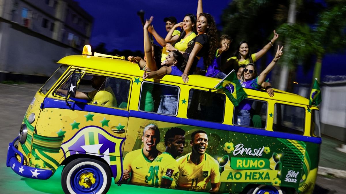 Brazilian fans celebrate in a Volkswagen Kombi vehicle decorated for the World Cup, after the match between Brazil and Serbia at the FIFA World Cup Qatar 2022, in Brasilia. Credit: Reuters Photo