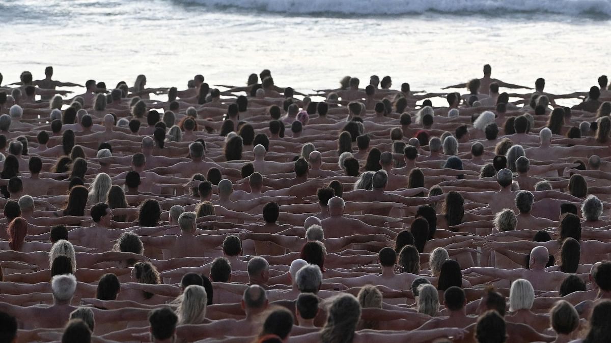 Participants pose nude during sunrise on Sydney's Bondi Beach for US art photographer Spencer Tunick, to raise awareness for skin cancer. Credit: AFP Photo
