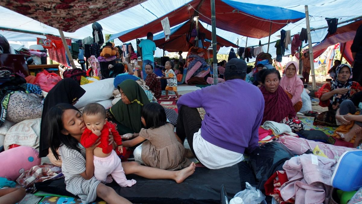 Villagers rest at a makeshift tent area as they are displaced after Monday's earthquake, in Cianjur, West Java province, Indonesia. Credit: Reuters Photo