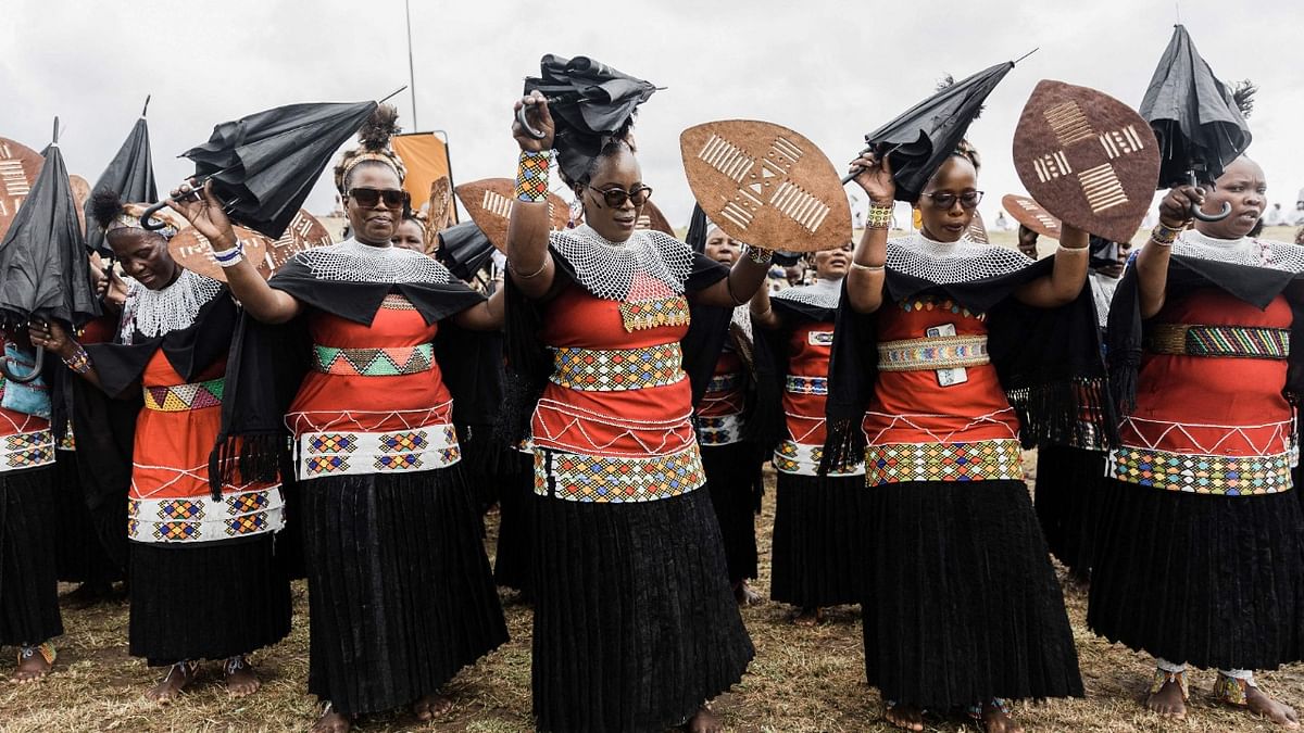 Women from the Nazareth Baptist Church, known as the Shembe Church, dressed in traditional attire, dance on the second day of the annual prayer and reconciliation ceremony at the Enyokeni Zulu Royal Palace in Nongoma, some 400 kilometres north of Durban. Credit: AFP Photo