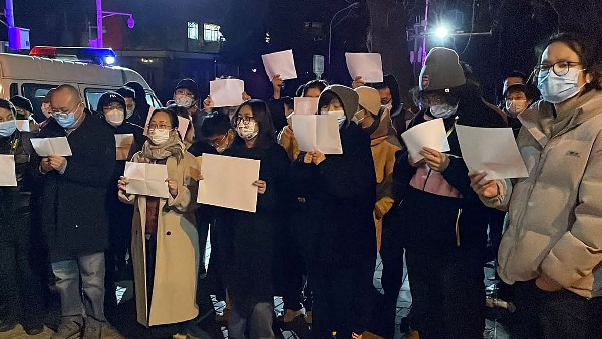 Protesters gather along a street during a rally for the victims of a deadly fire as well as a protest against China's harsh Covid-19 restrictions in Beijing. Credit: AFP Photo