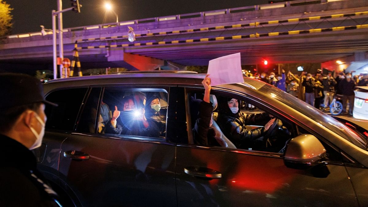 Cars honked in support as people remained in the area until early, chanting and waving blank sheets of paper symbolising censorship. Credit: Reuters Photo