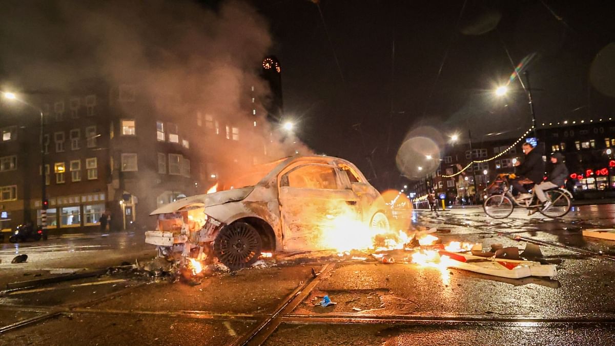 A car burns on the Mercatorplein on the sideline of the live broadcast of the Qatar 2022 World Cup Group F football match between Belgium and Morocco, in Amsterdam. Credit: AFP Photo