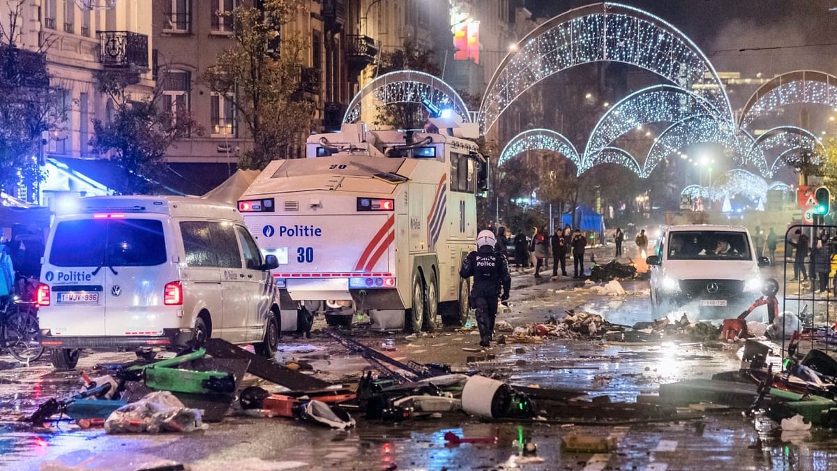 Police in the neighbouring Netherlands said violence erupted in the port city of Rotterdam, with riot officers attempting to break up a group of 500 soccer supporters who attacked police with fireworks and glass. Credit: AP Photo