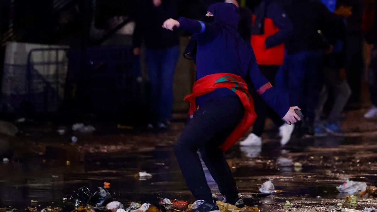 A man throws a stone during clashes after the World Cup match between Belgium and Morocco in Brussels. Credit: Reuters Photo