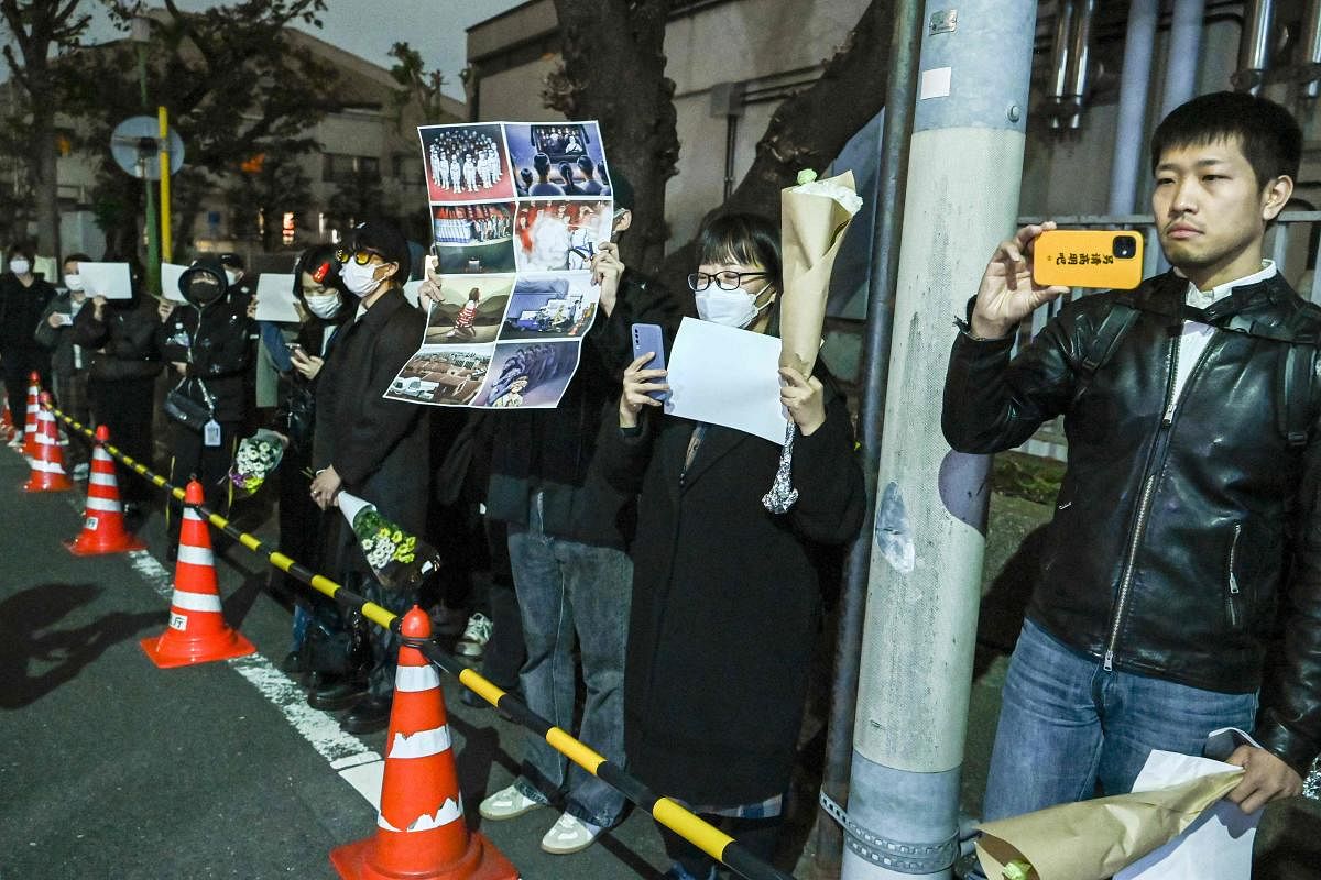 A group of protesters hold a peaceful gathering down the street from the Chinese embassy in Tokyo in support of demonstrations held in China over Beijing's Covid-19 restrictions. Credit: AFP Photo