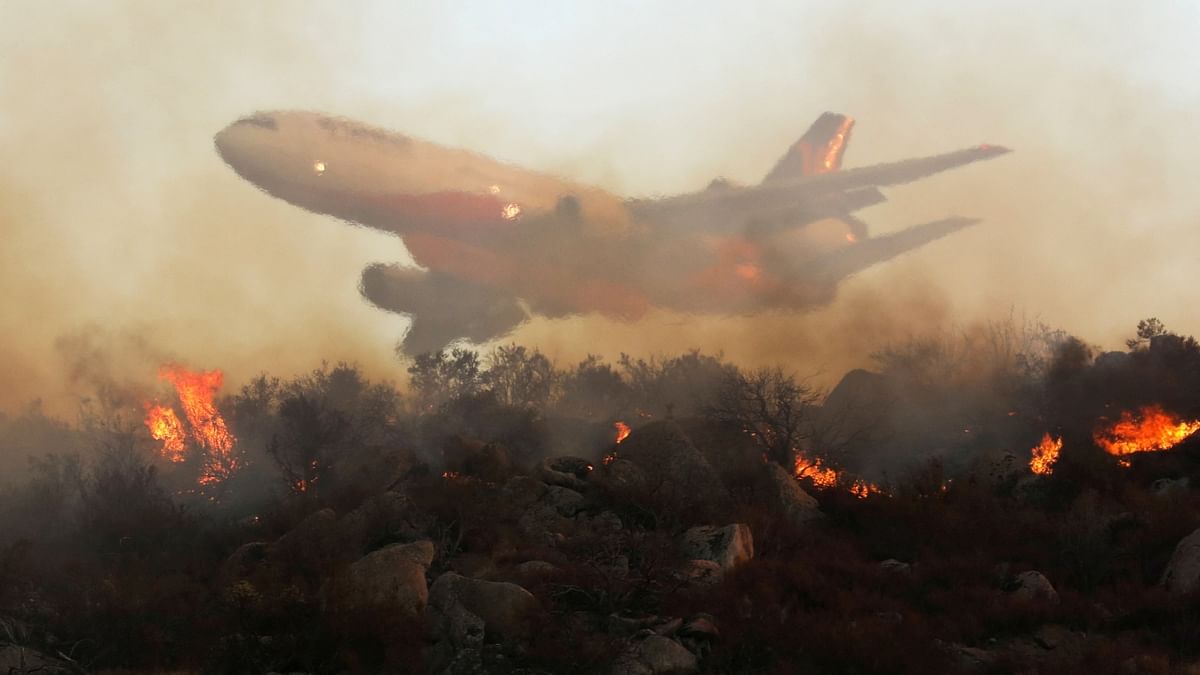 An aircraft drops retardant on the Fairview Fire burning near Hemet, California, US. Credit: Reuters Photo