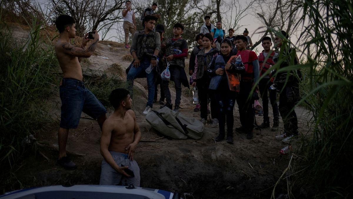 A group of migrants are photographed by smugglers before using a raft to cross the Rio Bravo del Norte, also known as the Rio Grande river, into the United States from Ciudad Miguel Aleman in Mexico. Credit: Reuters Photo