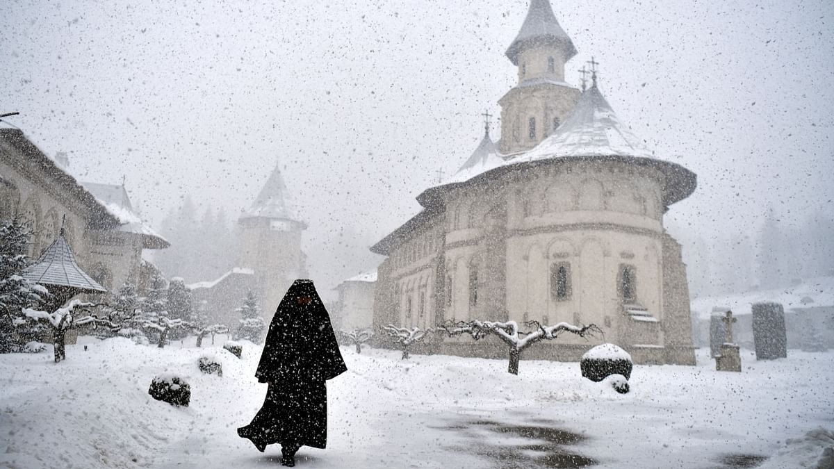 Romanian Orthodox monk, Father Mikhail, departs after the mass at the Church in Putna Monastery, Putna, Romania. During the mass, blessings were also given to Ukrainian refugees who are fleeing amid Russia's invasion. Credit: Reuters Photo