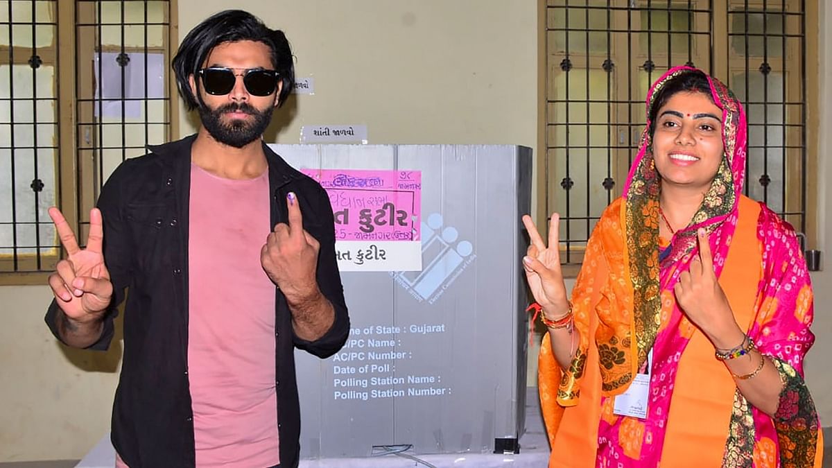 Cricketer Ravindra Jadeja with his wife and BJP candidate Rivaba Jadeja after casting his vote in Jamnagar. Credit: PTI Photo