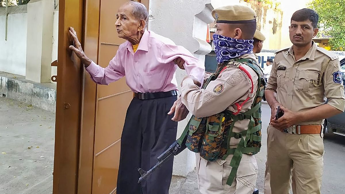 A policeman helps an elderly voter arrived to cast his vote in Rajkot. Credit: Twitter/@CollectorRjt