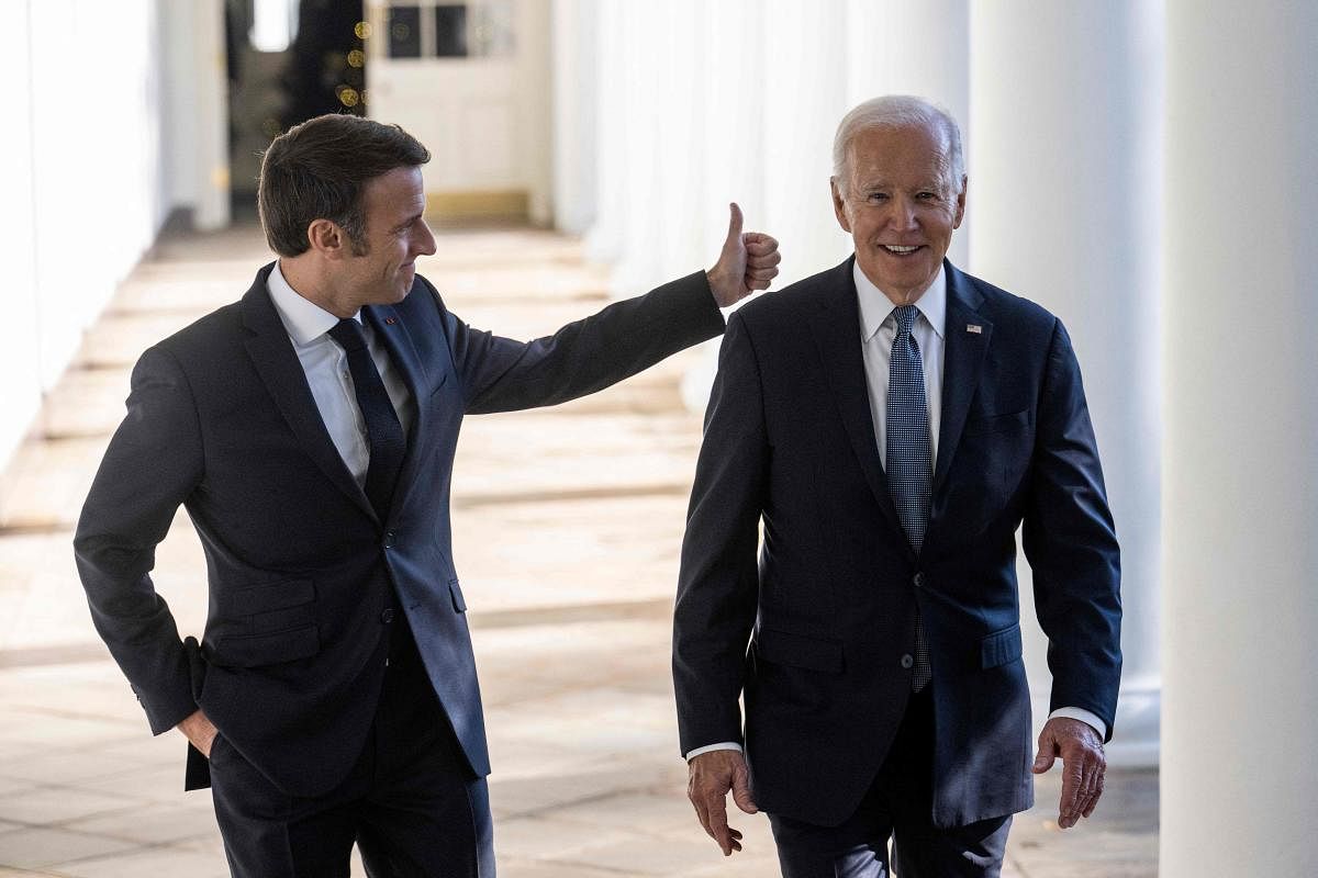 US President Joe Biden and French President Emmanuel Macron walk down the Colonnade at the White House in Washington, DC. Credit: AFP Photo