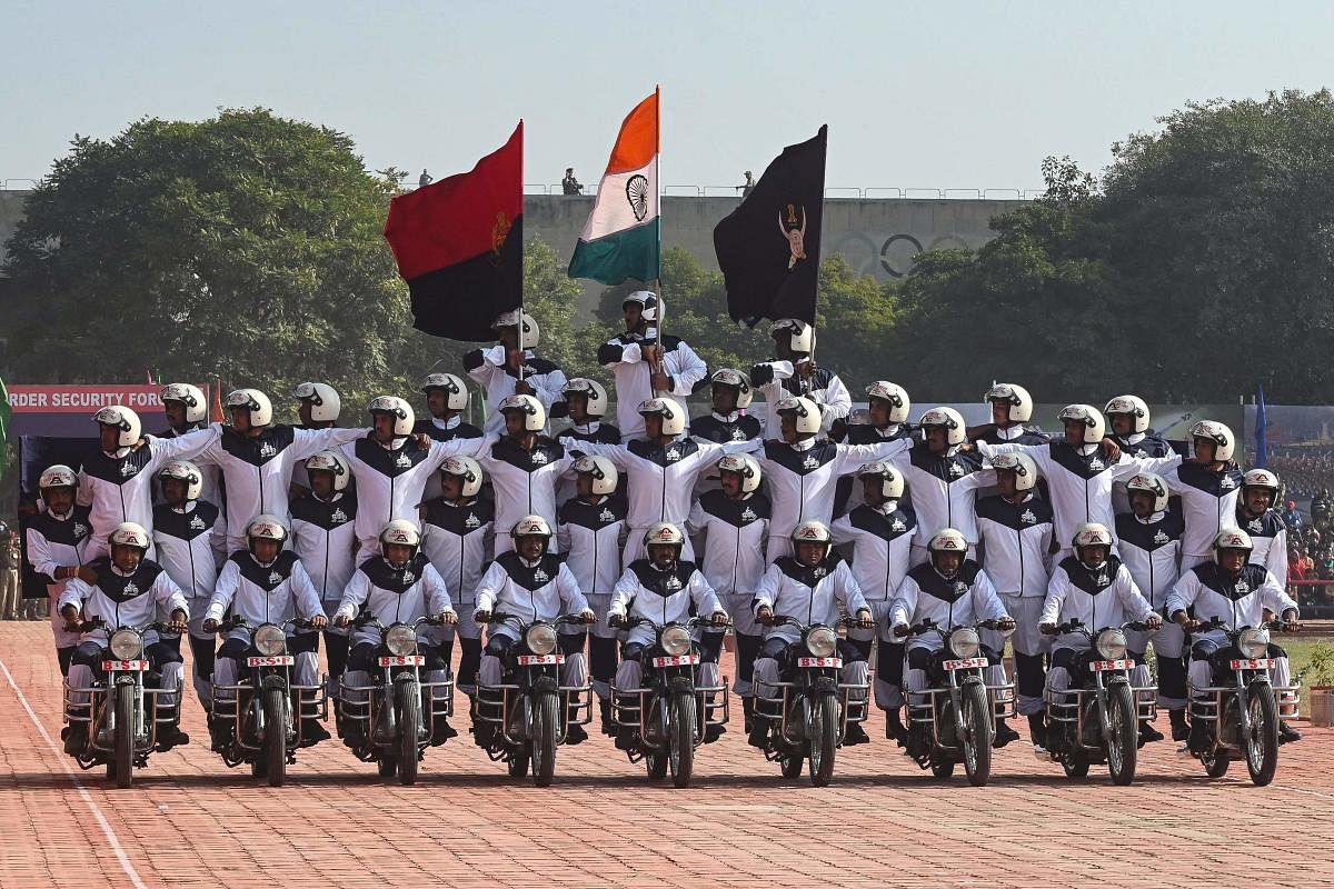 Border Security Force (BSF) personnel perform bike stunt during the 58th BSF Raising Day at Guru Nanak Dev University in Amritsar. Credit: AFP Photo