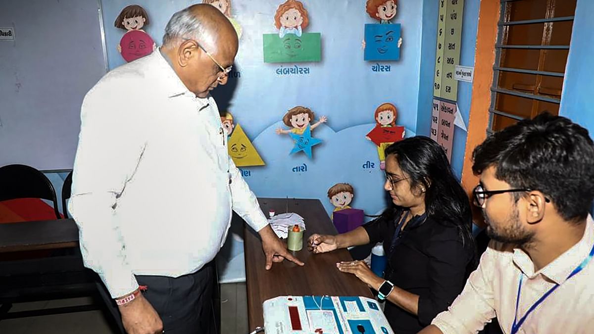 Gujarat Chief Minister Bhupendra Patel gets his finger inked before casting his vote at a polling booth during the second and final phase of Gujarat Assembly elections in Ahmedabad. Credit: Twitter/@Bhupendrapbjp