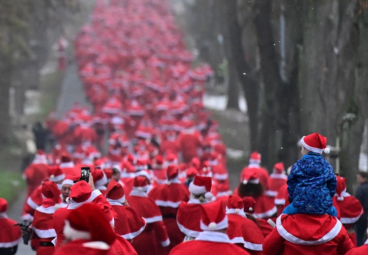 People dressed in Santa Claus costumes take part in the annual Christmas run in Michendorf. Credit: AFP Photo