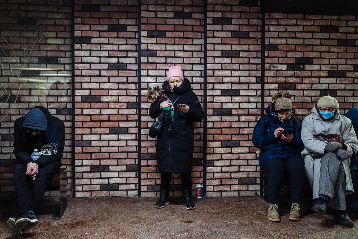 Civilians take shelter in an underground passage during an airstrike alert in the centre of Kyiv. Credit: AFP Photo