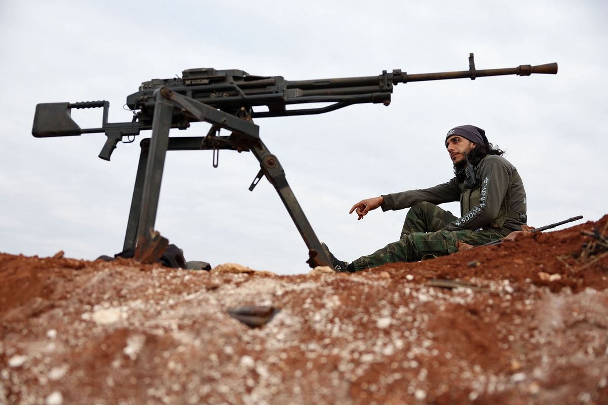 A Turkey-backed Syrian fighter sits at a position on the outskirts of the town of Marea, in the northern Aleppo countryside, along the frontline with areas held by the US-backed Kurdish-Arab alliance known as the Syrian Democratic Forces. Credit: AFP Photo