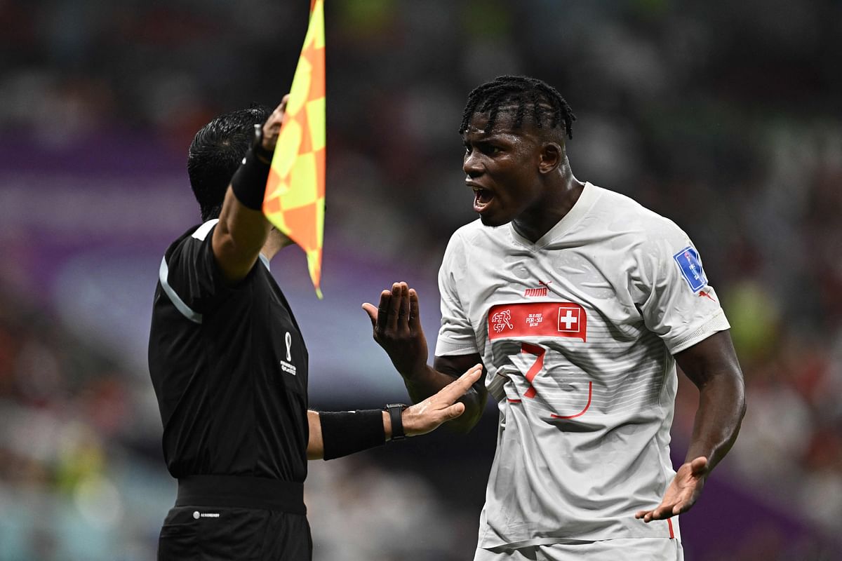 Switzerland's forward #07 Breel Embolo (R) argues with Mexican referee Cesar Ramos during the Qatar 2022 World Cup round of 16 football match between Portugal and Switzerland. Credit: AFP Photo