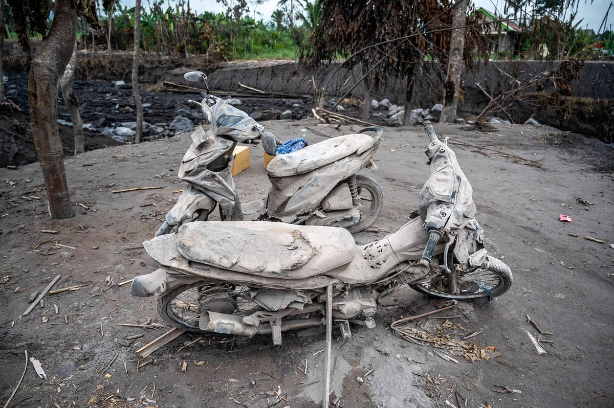 Damaged motorcyles are covered in ash at Kajar Kuning village in Lumajang on December 7, 2022, following the volcanic eruption of mount Semeru on December 4. Credit: AFP Photo