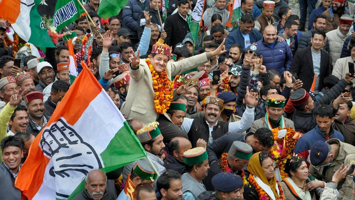 Congress candidate Sunder Singh Thakur celebrates his win with supporters on the counting day of the Himachal Pradesh Assembly elections, in Kullu. Credit: PTI Photo