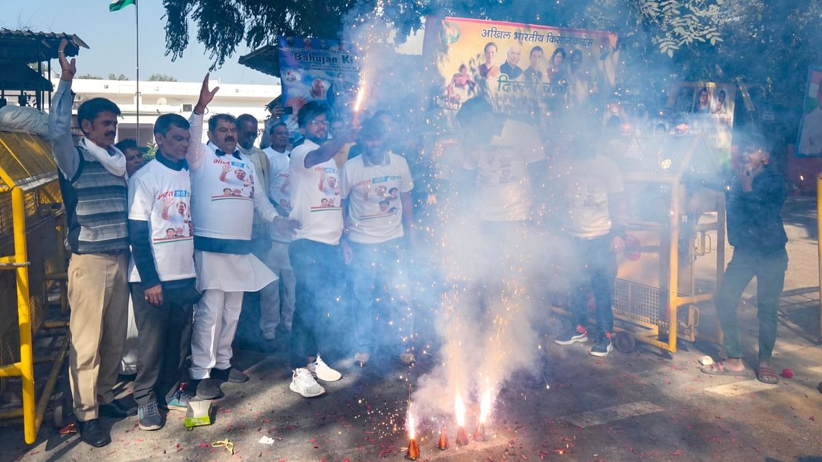 Congress workers burst firecrackers as they celebrate the party's performance in Himachal Pradesh Assembly elections, at AICC headquarters in New Delhi. Credit: PTI Photo