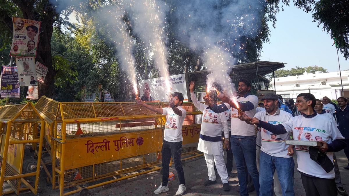 Congress workers burst firecrackers as they celebrate the party's lead in Himachal Pradesh Assembly elections, at AICC headquarters in New Delhi. Credit: PTI Photo