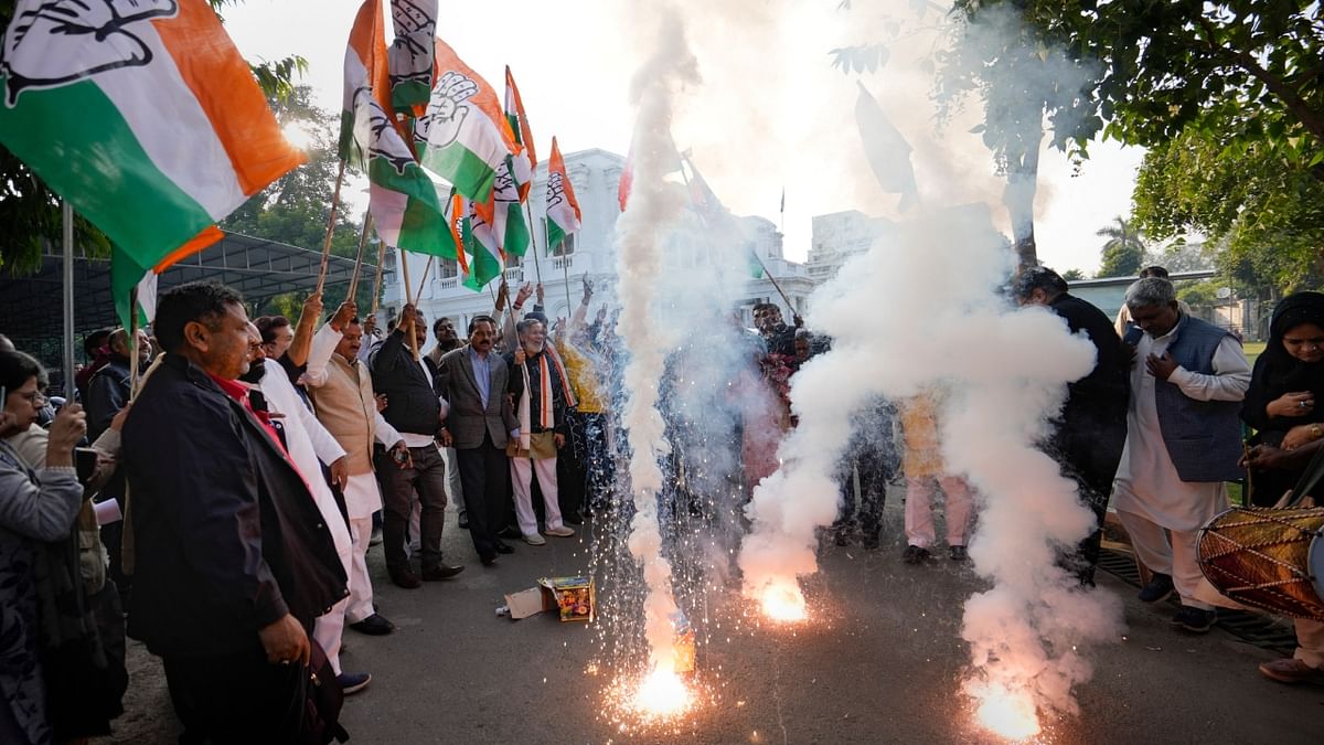 Congress workers burst firecrackers to celebrate the party's decisive lead in Himachal Pradesh Assembly Election, at the party office in Lucknow. Credit: PTI Photo