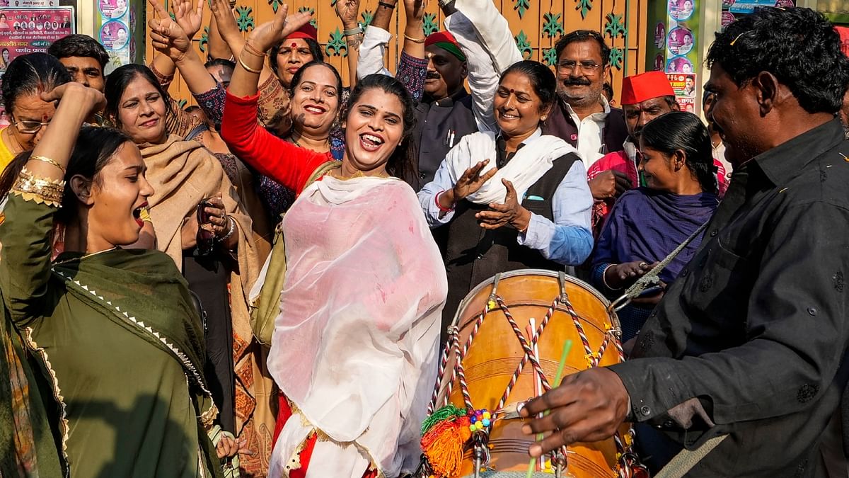 Samajwadi Party workers dance to the beat of dhols as they celebrate Dimple Yadav's win at Mainpuri by-election results, at the party office in Lucknow. Credit: PTI Photo