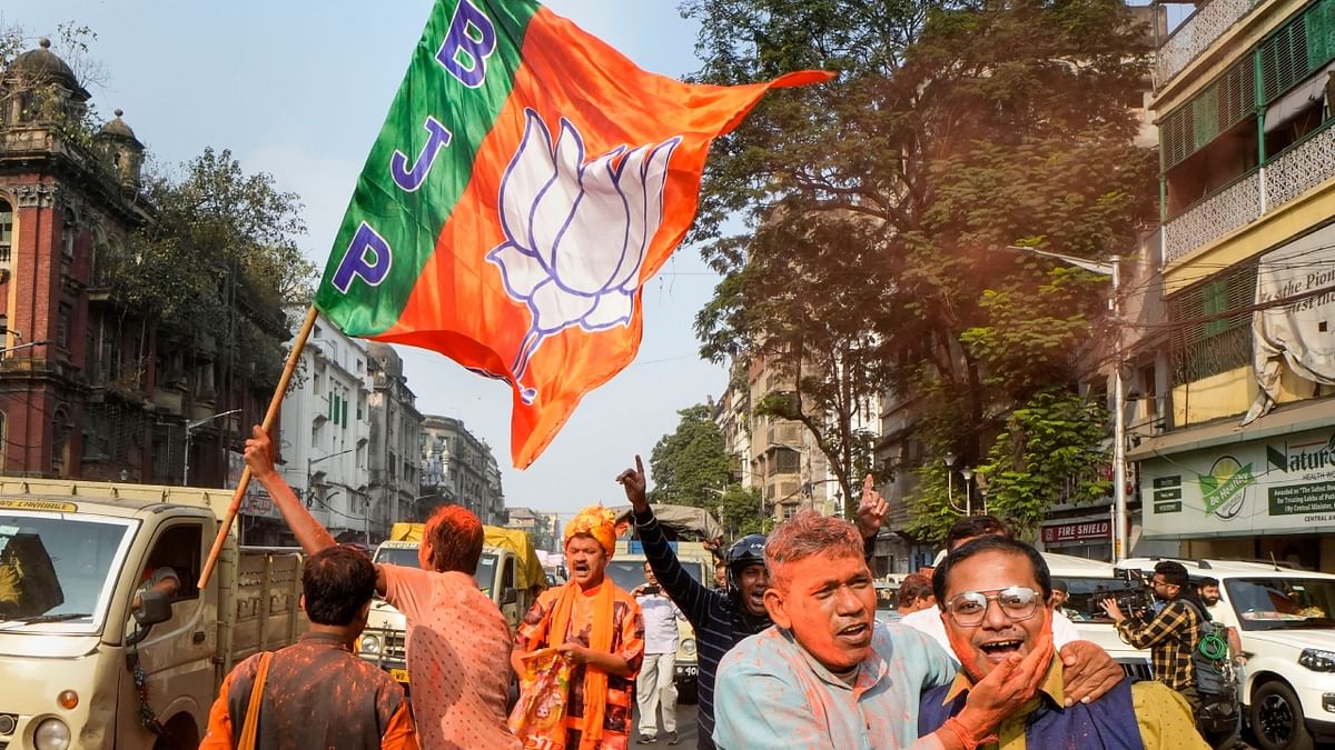 BJP workers celebrate the party's victory in the Gujarat Assembly elections, in Kolkata. Credit: PTI Photo