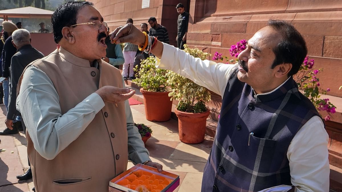 BJP MPs celebrate party's win in Gujarat Assembly elections at Parliament complex during the Winter Session, in New Delhi. Credit: PTI Photo