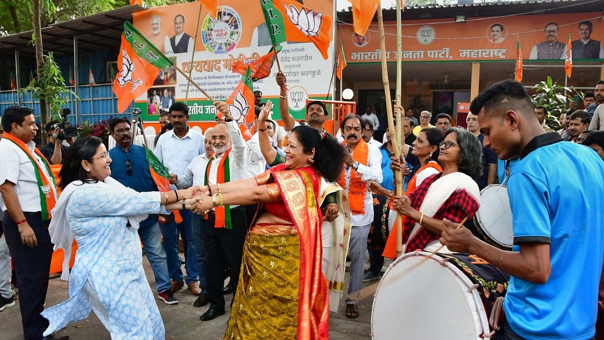 BJP leaders and workers dance to celebrate the party's win in Gujarat Assembly elections, outside BJP office in Mumbai. Credit: PTI Photo