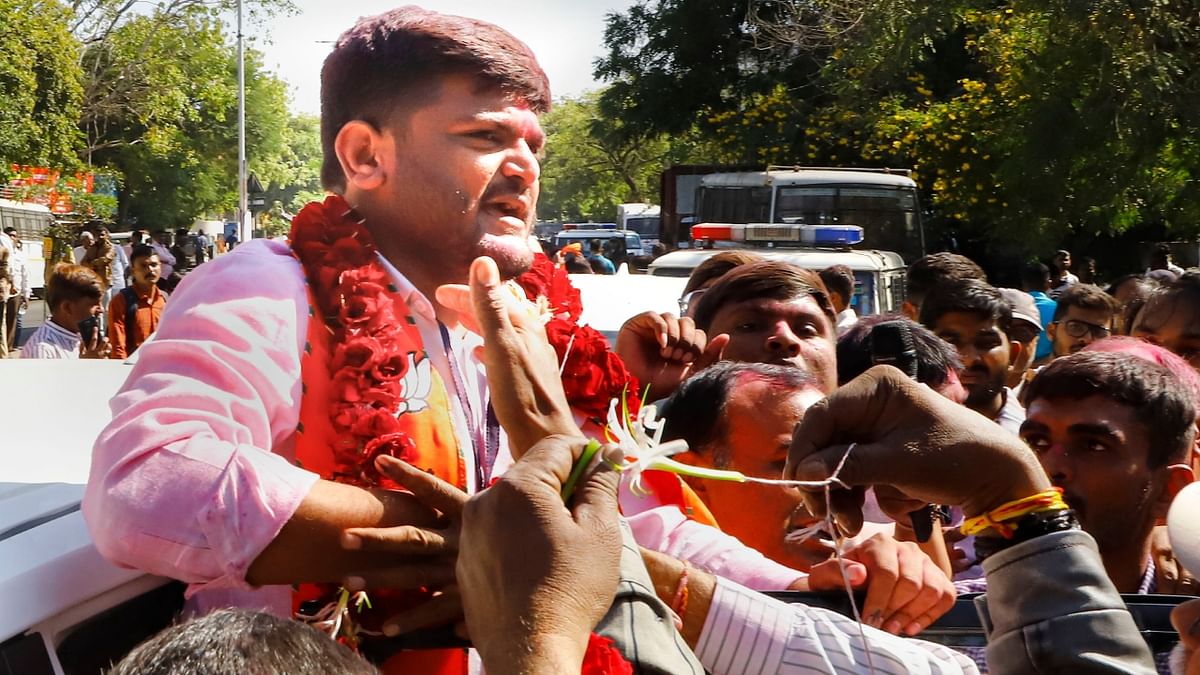 BJP candidate from Viramgam seat Hardik Patel celebrates his win with supporters outside a vote counting centre for the Gujarat Assembly elections, in Ahmedabad. Credit: PTI Photo