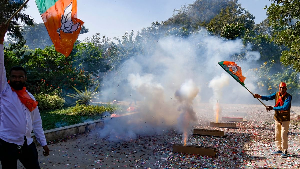 BJP workers burst crackers as they celebrate party's landslide victory in Gujarat Assembly elections, in Gandhinagar. Credit: PTI Photo