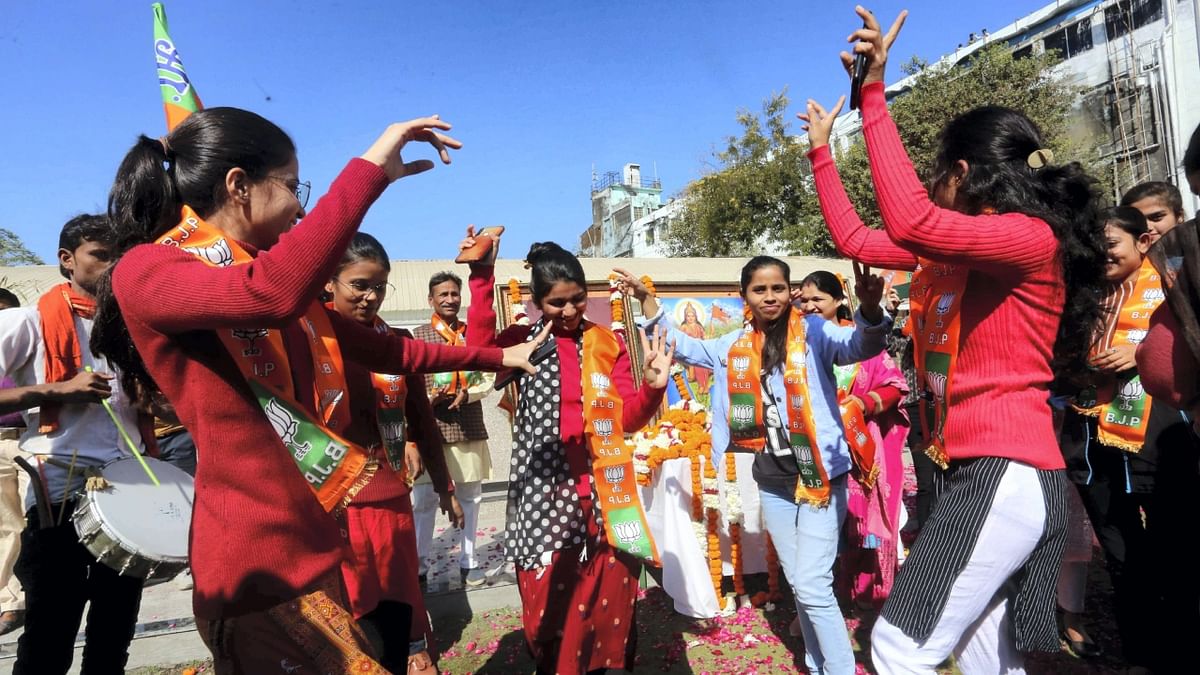 BJP supporters dance as they celebrate the party's decisive lead prior to the announcement of Gujarat Assembly elections results, in Bhopal. Credit: PTI Photo