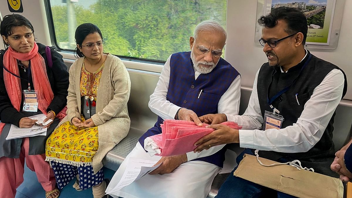 PM Modi interacted with passengers during his ride from Freedom Park Metro station to Khapri Metro Station, in Nagpur. Credit: Twitter/@CMOMaharashtra