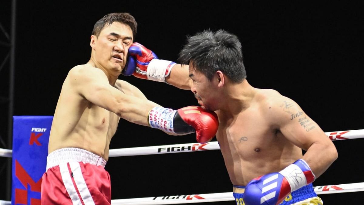 Manny Pacquiao (R) of the Philippines fights against DK Yoo of South Korea during their exhibition boxing match in Goyang. Credit: AFP Photo