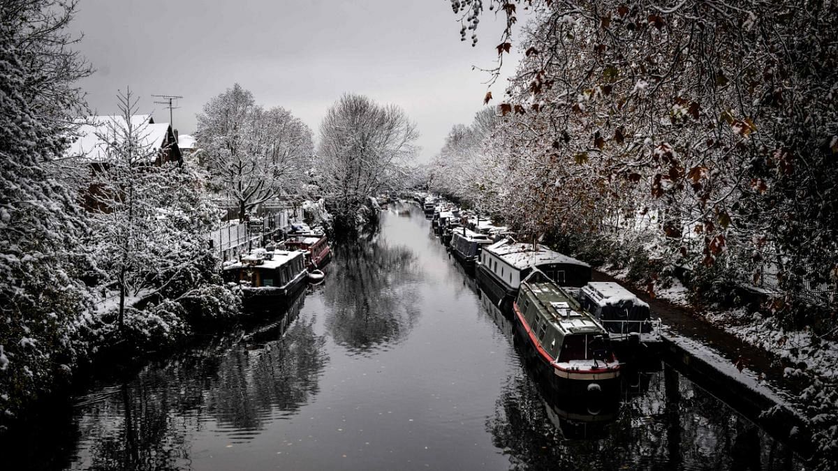 Snow covers trees and narrowboats along the Regent's Canal in east London. Credit: AFP Photo