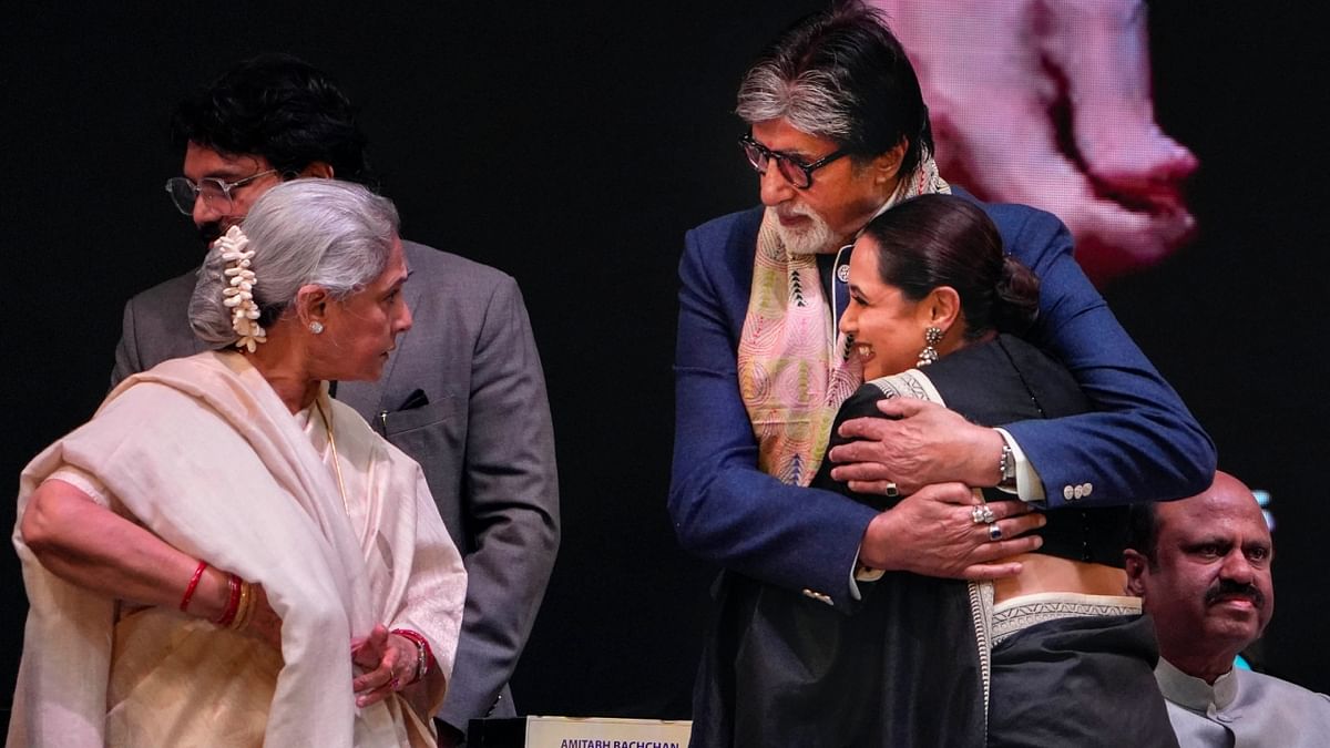 Actor-MP Jaya Bachchan looks on as Bollywood actors Amitabh Bachchan and Rani Mukerji exchange greetings. Credit: PTI Photo