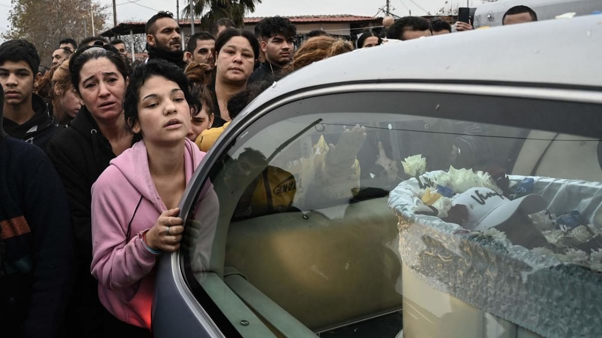 Relatives and friends of the 16-year-old Roma boy who was shot in the head by Greek police follow a hearse with the coffin during the funeral, in Thessaloniki. Credit: AFP Photo