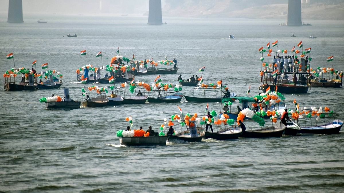 Indian Army, NCC, Jal Police, local boat clubs members with decorated boats that had banners and the national flags took part in a boat race during the Vijay Diwas celebrations, at Sangam in Prayagraj. Credit: PTI Photo